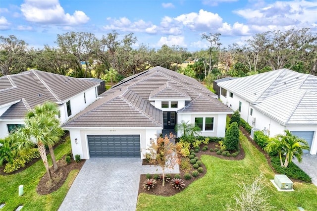 view of front of house with a garage and a front lawn