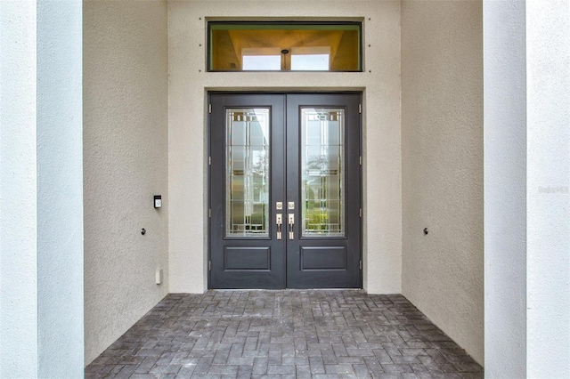 view of exterior entry featuring french doors