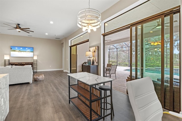 dining space featuring dark hardwood / wood-style floors and ceiling fan with notable chandelier