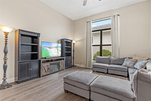 living room with ceiling fan and hardwood / wood-style flooring