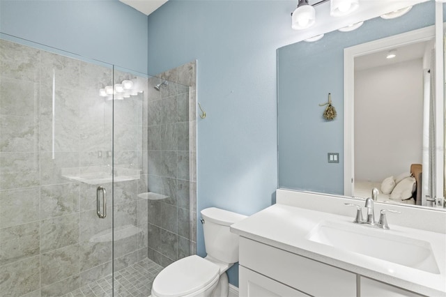 bathroom with an enclosed shower, vanity, and toilet