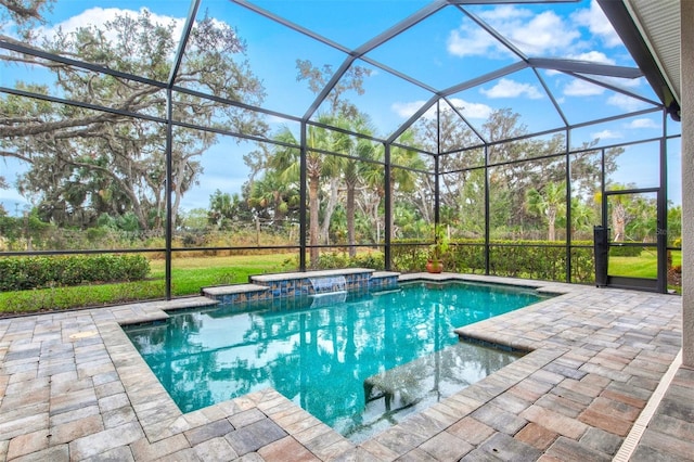 view of pool featuring a lanai, a patio area, and an in ground hot tub