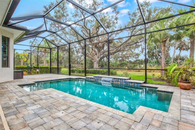 view of pool featuring a lanai, pool water feature, and a patio area