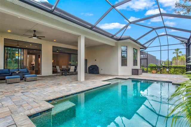 view of swimming pool featuring a lanai, ceiling fan, outdoor lounge area, and a patio