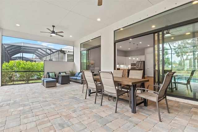 view of patio featuring ceiling fan, a lanai, an outdoor hangout area, and area for grilling