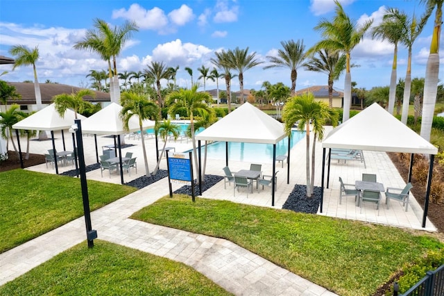 view of swimming pool with a gazebo and a lawn