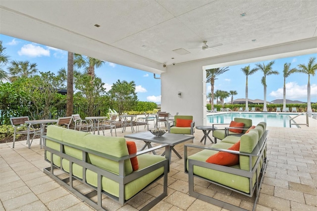 view of patio / terrace with ceiling fan and a community pool