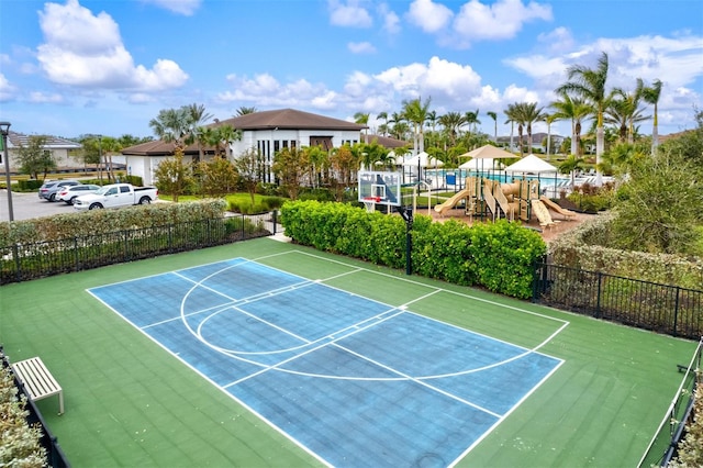 view of sport court featuring a playground