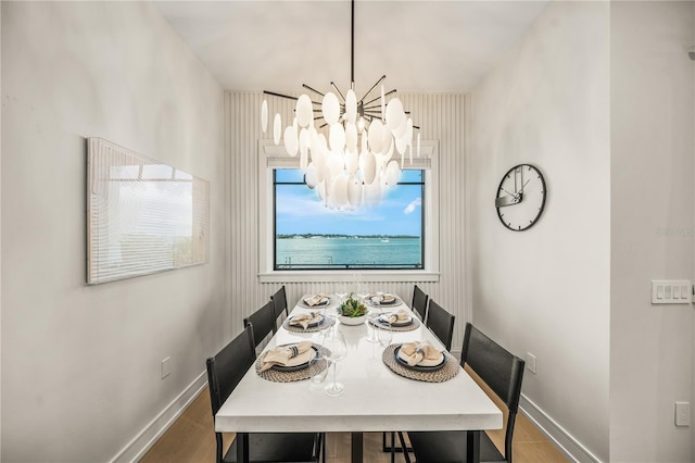 dining room with hardwood / wood-style flooring and a notable chandelier