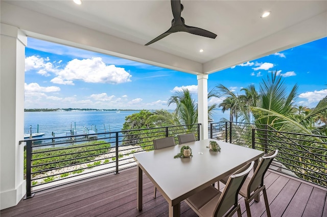 deck with ceiling fan and a water view