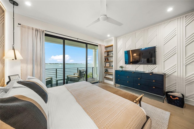 bedroom with access to exterior, ceiling fan, and light hardwood / wood-style floors