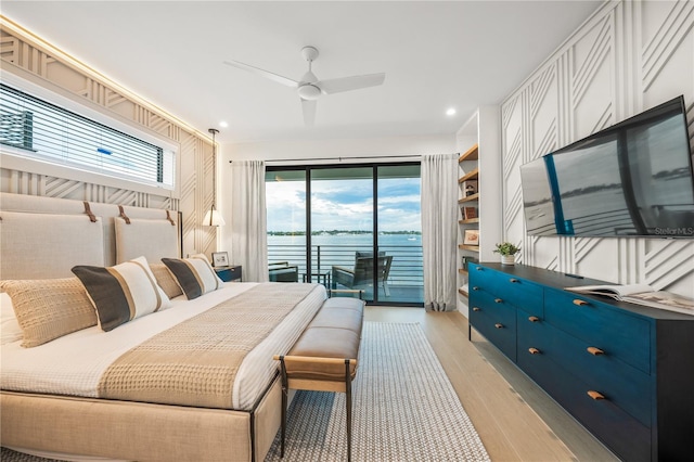 bedroom featuring access to exterior, light hardwood / wood-style floors, and ceiling fan