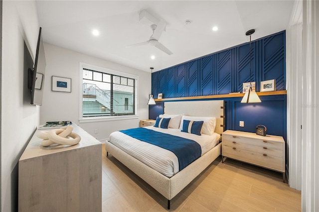 bedroom with ceiling fan and light hardwood / wood-style flooring