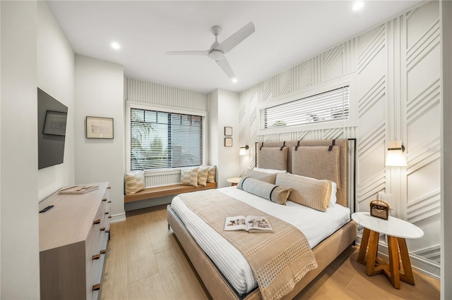 bedroom featuring ceiling fan and light hardwood / wood-style flooring