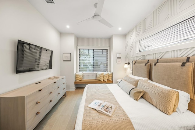 bedroom with light wood-type flooring and ceiling fan