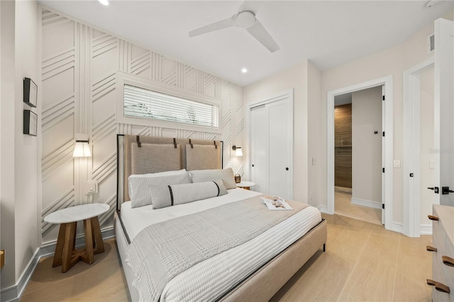 bedroom featuring a closet, light hardwood / wood-style flooring, and ceiling fan