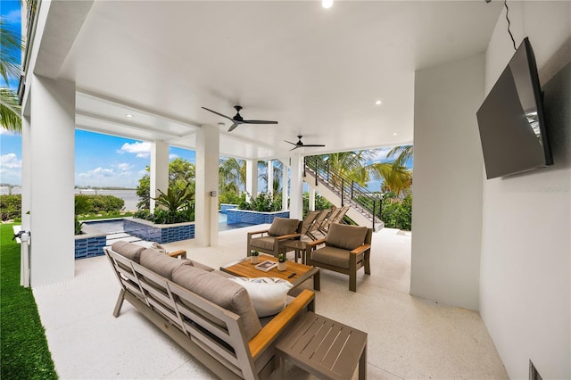 view of patio / terrace with an outdoor living space, a swimming pool with hot tub, and ceiling fan