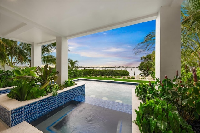 pool at dusk with a jacuzzi