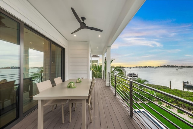 balcony featuring ceiling fan and a water view