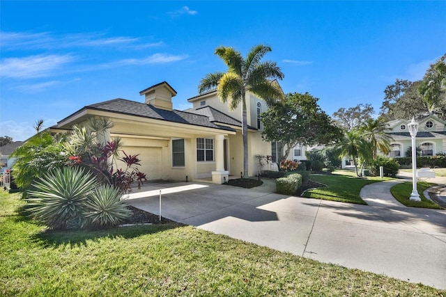 view of front of home with a garage and a front lawn