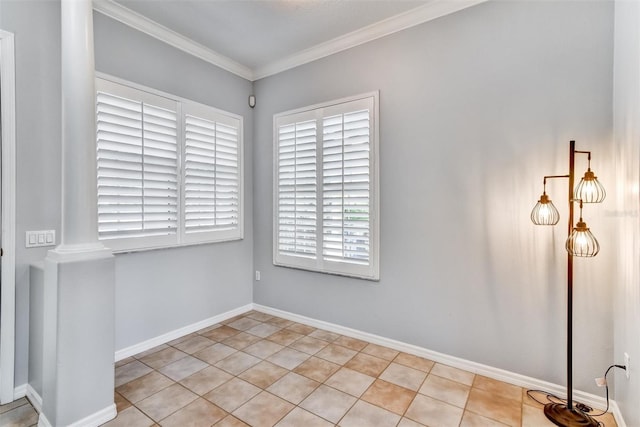 tiled empty room featuring crown molding and ornate columns