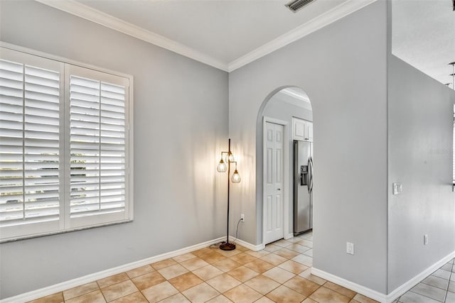 tiled spare room featuring ornamental molding