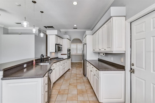 kitchen with light tile patterned floors, sink, appliances with stainless steel finishes, white cabinetry, and hanging light fixtures