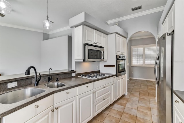 kitchen with stainless steel appliances, light tile patterned flooring, white cabinets, and decorative light fixtures