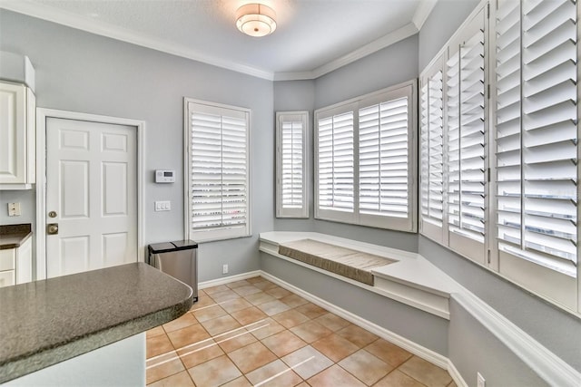 interior space featuring ornamental molding and light tile patterned floors