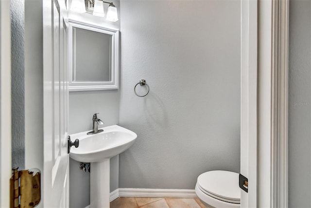 bathroom featuring sink, tile patterned floors, and toilet