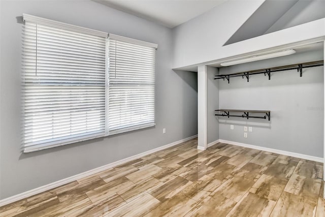 interior space featuring vaulted ceiling and a closet