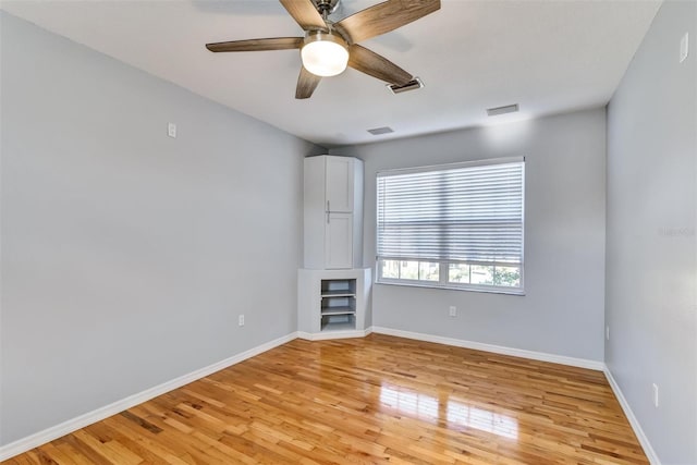 unfurnished room featuring light hardwood / wood-style flooring and ceiling fan