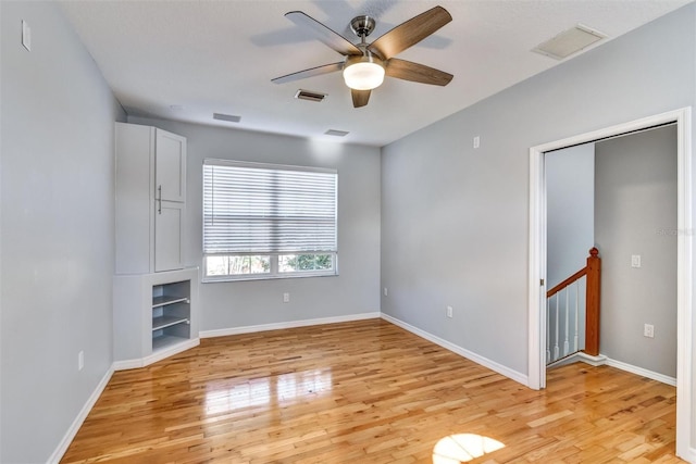 unfurnished room featuring light hardwood / wood-style floors and ceiling fan