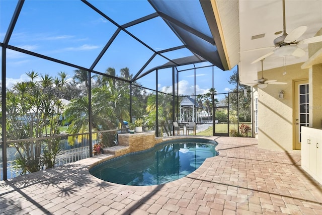 view of pool with a lanai, ceiling fan, and a patio area