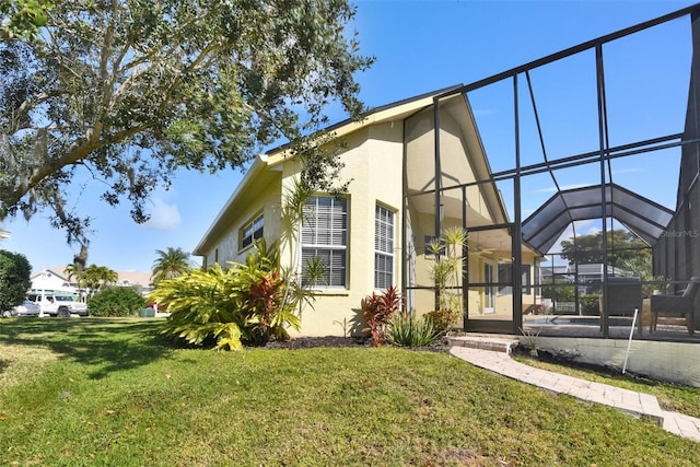 exterior space with a yard and glass enclosure