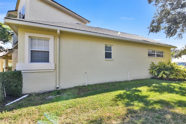 view of property exterior with a yard