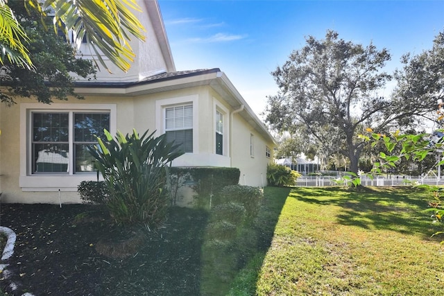 view of side of home featuring a lawn