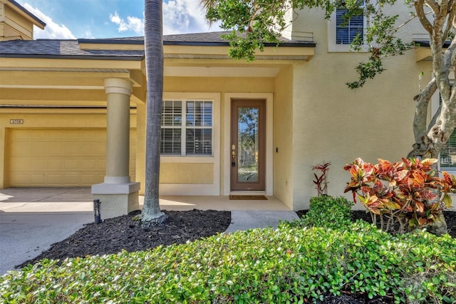 4708 Clipper Dr, Bradenton, FL 34208 - property entrance featuring driveway, stucco siding, roof with shingles, and an attached garage