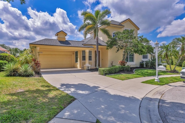 4708 Clipper Dr, Bradenton, FL 34208 - view of front of property featuring concrete driveway, a garage, stucco siding, and a front yard