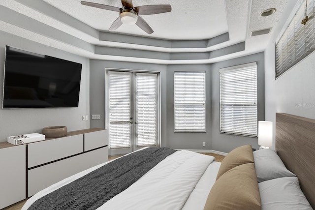 4708 Clipper Dr, Bradenton, FL 34208 - bedroom with a textured ceiling, ceiling fan, a raised ceiling, baseboards, and access to exterior