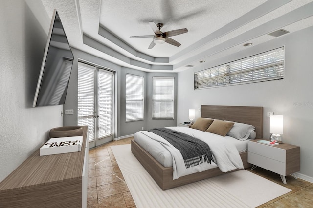 4708 Clipper Dr, Bradenton, FL 34208 - bedroom featuring a ceiling fan, access to exterior, a textured ceiling, a raised ceiling, and light tile patterned flooring