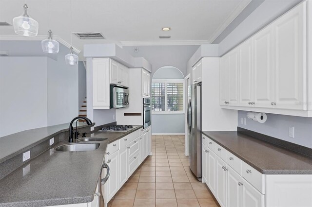 4708 Clipper Dr, Bradenton, FL 34208 - kitchen featuring dark countertops, stainless steel appliances, light tile patterned flooring, and a sink