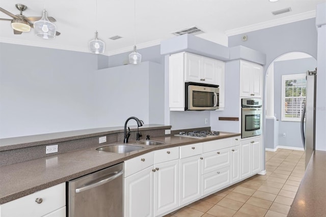 4708 Clipper Dr, Bradenton, FL 34208 - kitchen featuring visible vents, a sink, crown molding, dark countertops, and appliances with stainless steel finishes