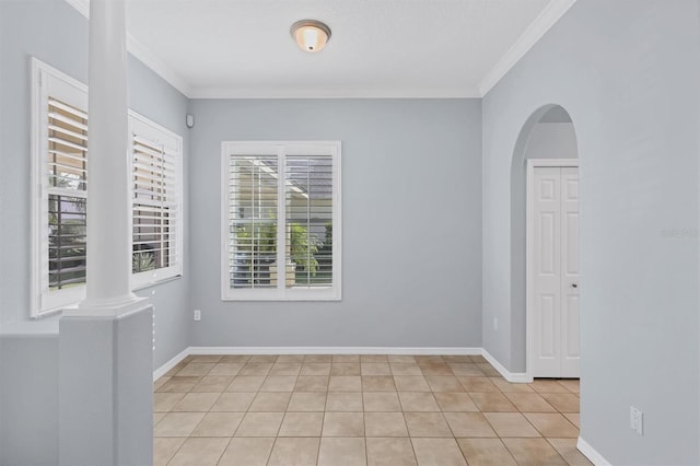 4708 Clipper Dr, Bradenton, FL 34208 - spare room featuring arched walkways, ornamental molding, light tile patterned flooring, and ornate columns