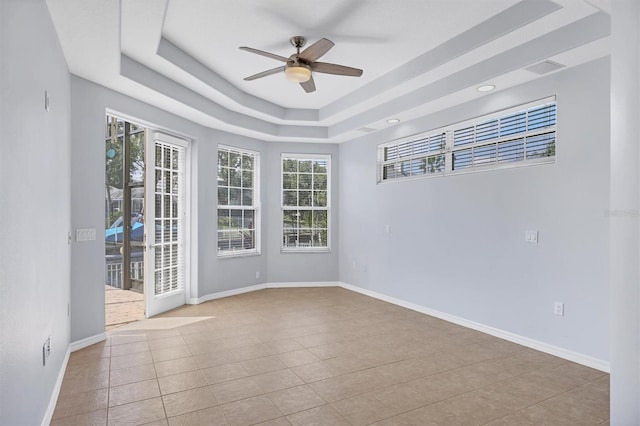 4708 Clipper Dr, Bradenton, FL 34208 - tiled spare room with baseboards, a raised ceiling, and ceiling fan
