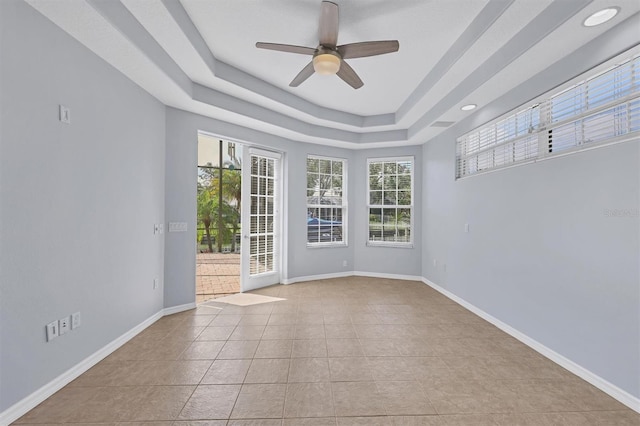 4708 Clipper Dr, Bradenton, FL 34208 - spare room featuring a tray ceiling, tile patterned floors, baseboards, and a ceiling fan
