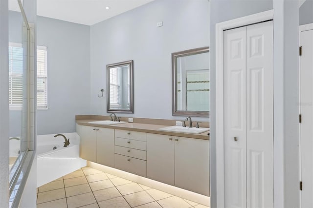 4708 Clipper Dr, Bradenton, FL 34208 - bathroom with tile patterned floors, a closet, a garden tub, and a sink