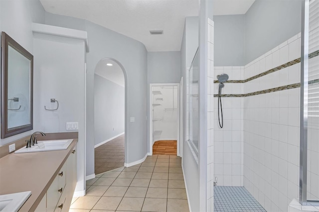 4708 Clipper Dr, Bradenton, FL 34208 - full bath featuring vanity, tiled shower, visible vents, and tile patterned flooring