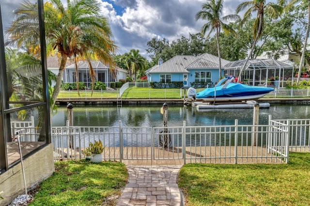 4708 Clipper Dr, Bradenton, FL 34208 - view of dock featuring boat lift, a yard, a water view, and fence