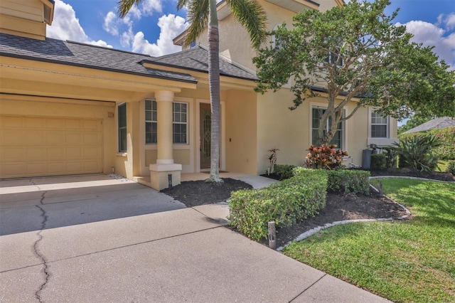 4708 Clipper Dr, Bradenton, FL 34208 - view of front facade featuring a shingled roof, stucco siding, driveway, and a garage